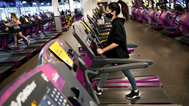 On February 1, 2021, Planet Fitness in Dorchester, Boston, will reopen to a quarter of its previous capacity. A person works out there.